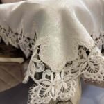 Elegant beige jacquard tablecloth with detailed floral lace edges and center design. Ideal for upscale dining, events, or daily luxury. Elegant beige jacquard tablecloth with detailed floral lace edges and center design. Ideal for upscale dining, events, or daily luxury.