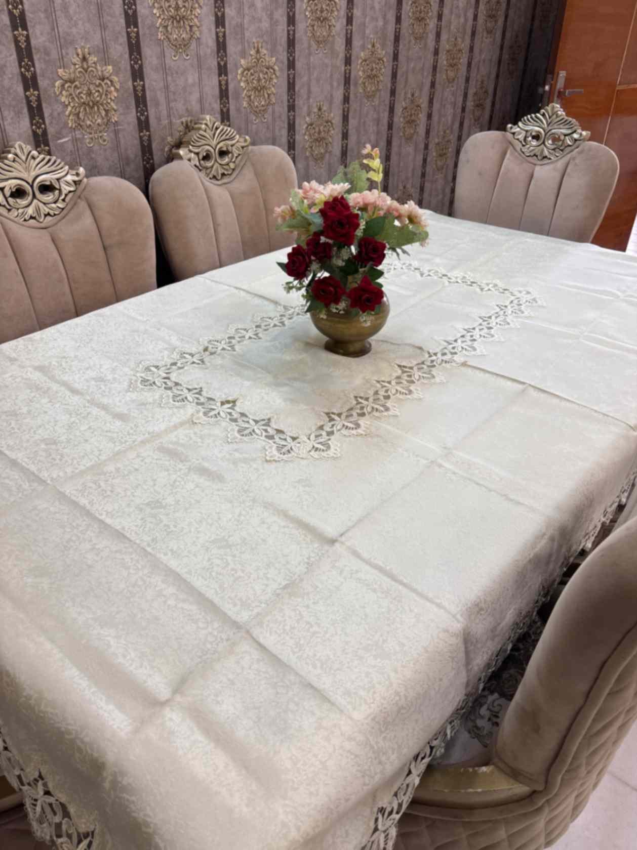 Elegant beige jacquard tablecloth with detailed floral lace edges and center design. Ideal for upscale dining, events, or daily luxury.