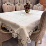 Elegant beige jacquard tablecloth with detailed floral lace edges and center design. Ideal for upscale dining, events, or daily luxury. Elegant beige jacquard tablecloth with detailed floral lace edges and center design. Ideal for upscale dining, events, or daily luxury.