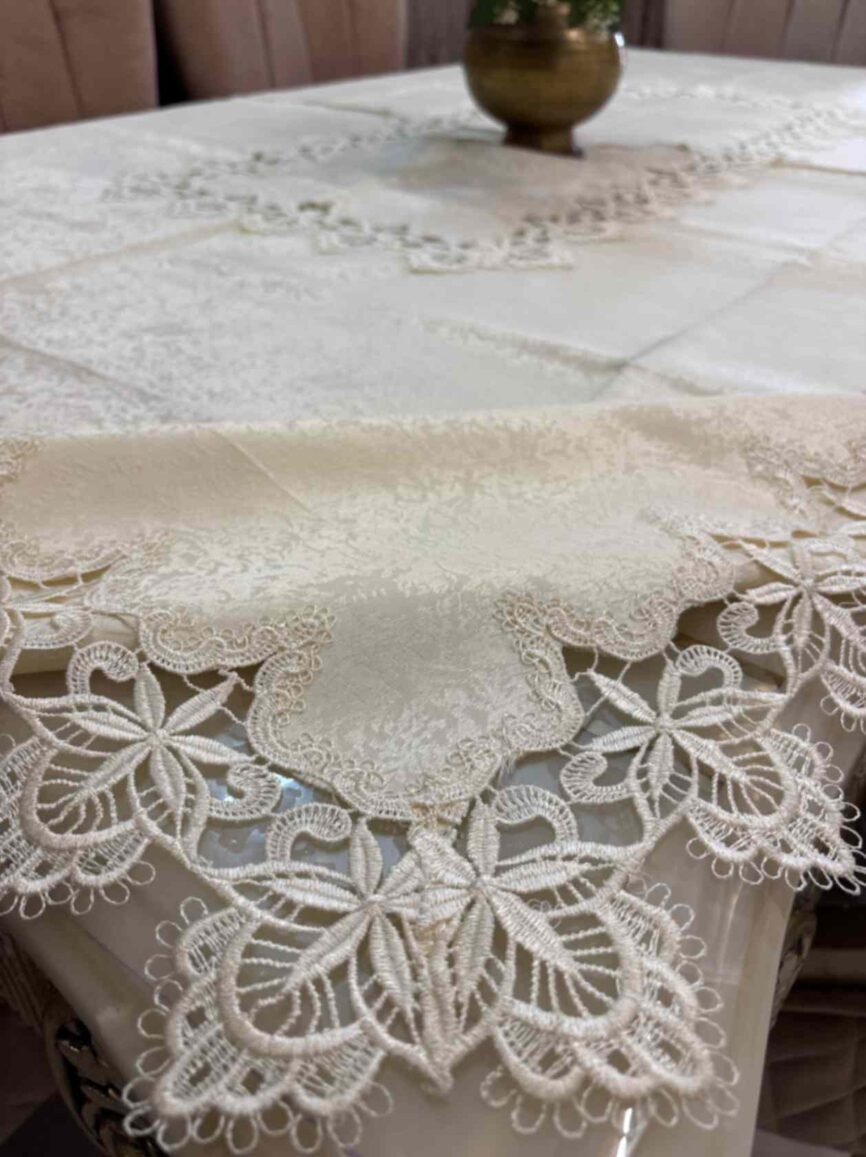 Elegant beige jacquard tablecloth with detailed floral lace edges and center design. Ideal for upscale dining, events, or daily luxury.